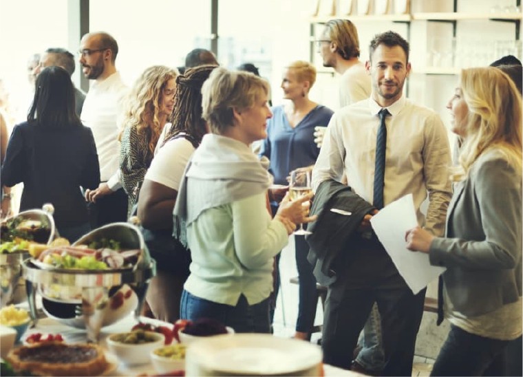 Guests mingling at a catered corporate meeting